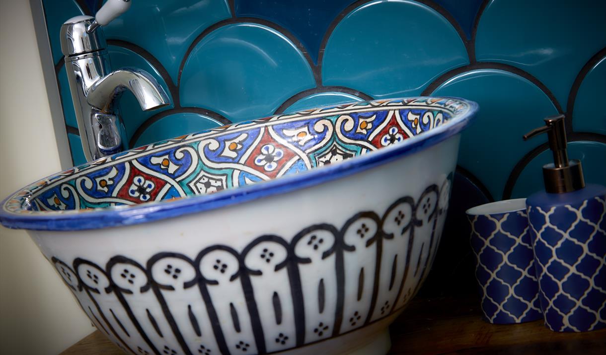 A blue feature patterned sink bowl at North Star Sanctum in East Yorkshire.