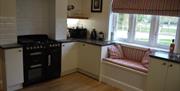 The kitchen with snug seating fitted underneath the kitchen window at Stacey Cottage in East Yorkshire.