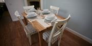 A set table in dining area at Sewerby Hall Cottages in East Yorkshire.