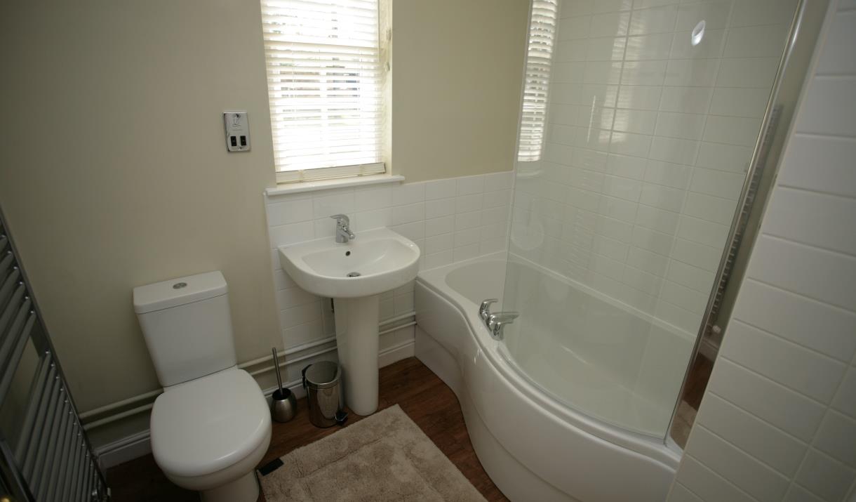 A bathroom with over bath shower at Sewerby Hall Cottages in East Yorkshire.