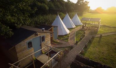 Tipis and hut at Wild Harvest School, Cottingwith, East Yorkshire.