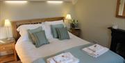 A double bedroom with feature fireplace at Pond View Cottage in East Yorkshire.