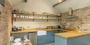 A lovely kitchen with small seating area at Bolthole Cottage in East Yorkshire.