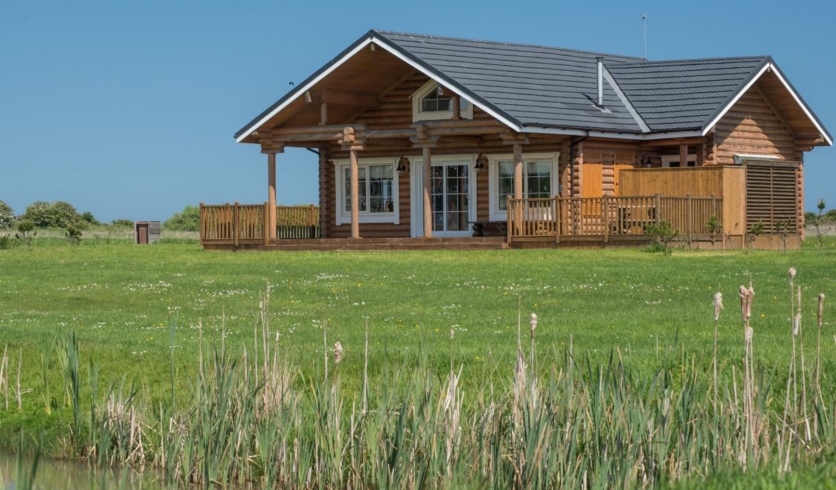 A large lodge with grassed surrounding at Lakeside Lodges in East Yorkshire.