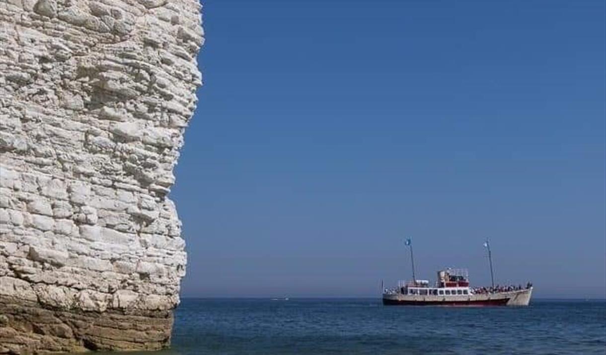 The Yorkshire Belle pleasure cruiser on a blue sea near the white cliffs of Bempton