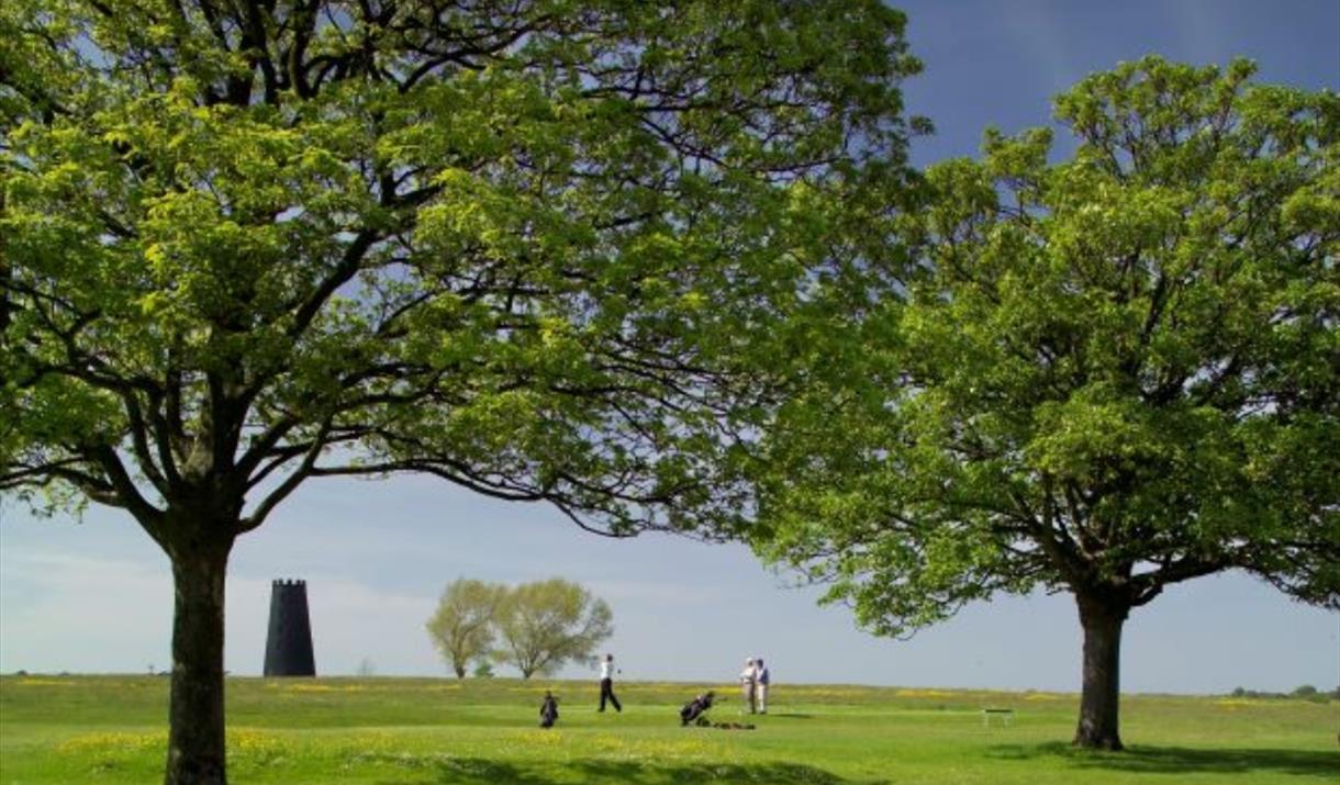 The Black Mill with golfers on the golf course in Beverley, East Yorkshire.