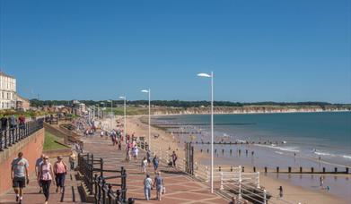 People walking along the promenade and on the North beach at Bridlington in East Yorkshire.