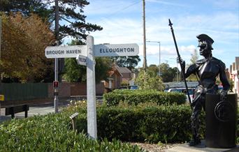 The sculpture of a centurion, and a fingerpost,  at Brough crossroads in East Yorkshire.
