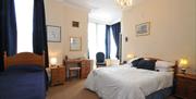 A bedroom with a double bed and a single bed at Lincoln House in East Yorkshire.