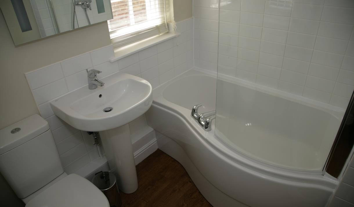 A bathroom with over bath shower at Sewerby Hall Cottages in East Yorkshire.



