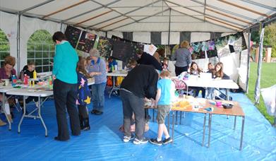 People doing crafts in a marquee