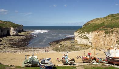 Overlooking the cove at north landing, including the cliffs, beach and cobble boats, in East Yorkshire