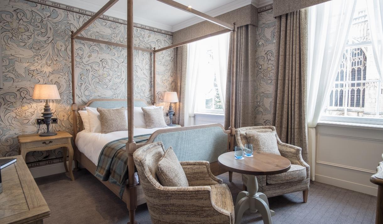 A four poster bed and seating area in a double room at The Beverley Arms in East Yorkshire.