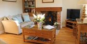 The living room and log burner at Pond View Cottage in East Yorkshire.