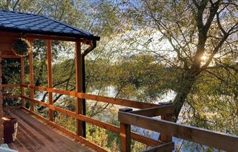 View of the lake from the cabin at sunset at Kingfisher Lakes Glamping & Lodges, Brandesburton, East Yorksh