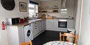 Image of Kitchen; cooker / oven and washing machine.