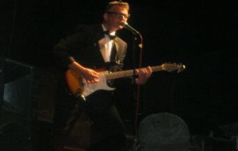 Buddy Holly playing the guitar