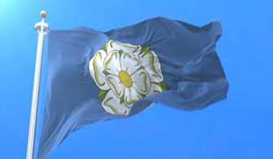 Yorkshire flag flying against an blue sky