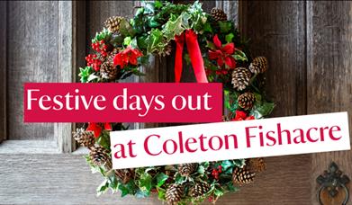 Red and green Christmas wreath hanging on a wooden door, with the words 'Festive days out at Coleton Fishacre'/.