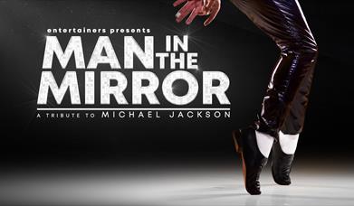 image of the logo and a pair of feet in white socks and black shoes 