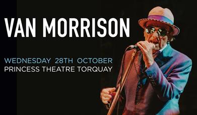 photo of Van Morrison performing on stage wearing a hat and sunglasses