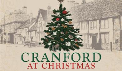 Cranford at Christmas at the Little Theatre, Torquay. A decorated christmas tree in front of an olde worlde street scene.