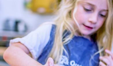 A child cooking at Occombe Farm