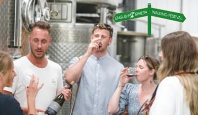 A group of people taste wines at Sharpham Wines, Sandridge Barton