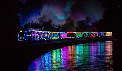 Train of Lights reflecting in the water, Paignton to Dartmouth Steam Railway, Paignton, Devon