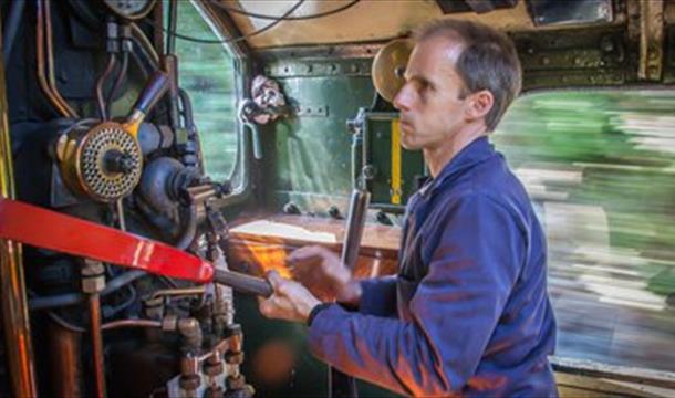 A man working as a steam train driver, Dartmouth Rail and River Boat Company. The Footplate Experience. Paignton to Kingswear.