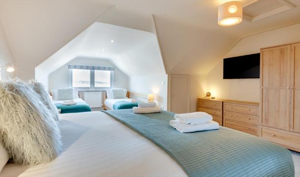 Old Ice House, Brixham holiday accommodation. Double bedroom with view from window to sea.