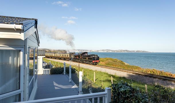 View of the steam train passing Waterside Holiday Park, Paignton, Devon