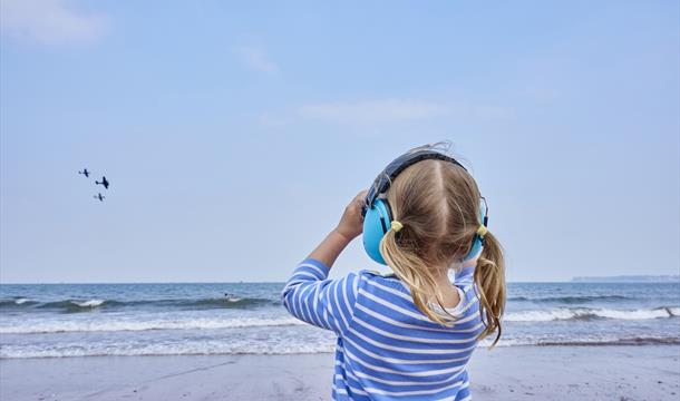 Child watching the English Riviera Airshow, Paignton, Devon