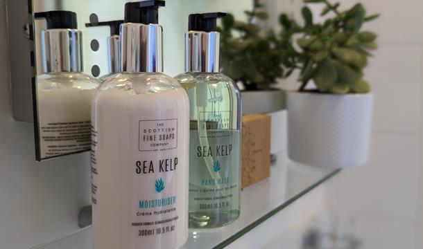 Bathroom shelf with complimentary luxury toiletries