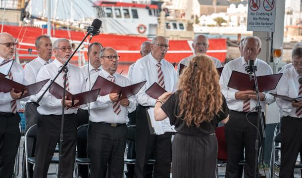 Brixham Orpheus Male Voice Choir Concert Old Fish Quay Brixham men singing on the quay