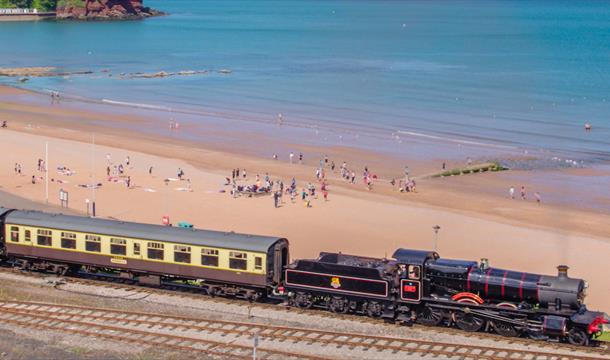 Steam train going past at Goodrington Sands in Paignton, Devon