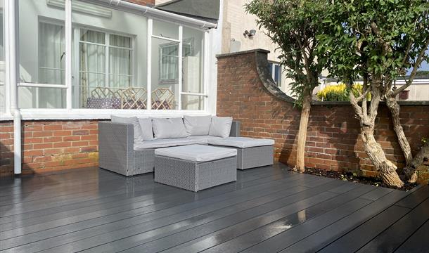 Back garden with sofa to relax on