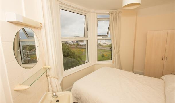 Bedroom with a view at Adelphi Holiday Apartments in Paignton, Devon