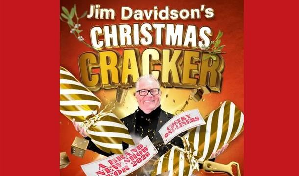 a picture of Jim Davidson with a giant gold and cream stripped cracker