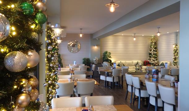 Christmas decorations surrounding tables and chairs ready for dining inside the cafe