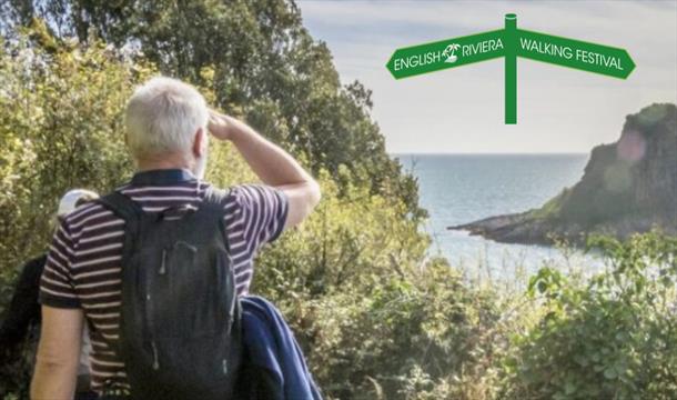 A man looks out to sea from the South West Coast Path.