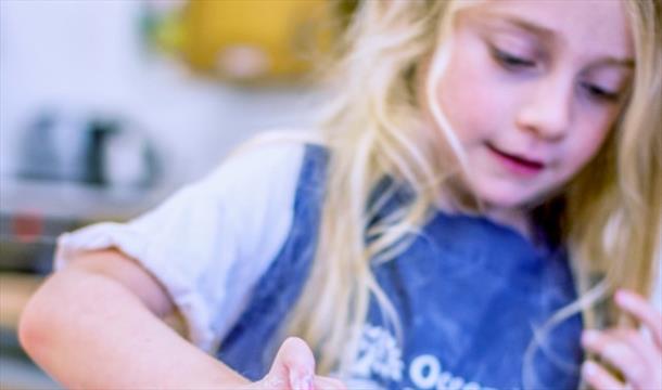 A child cooking at Occombe Farm