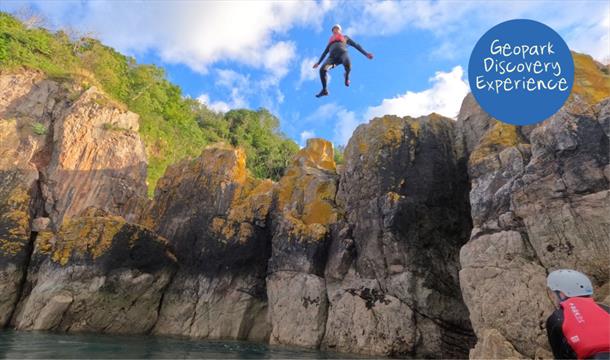 An individual jumping into the sea, Geopark Coasteering Tour, Reach Outdoors