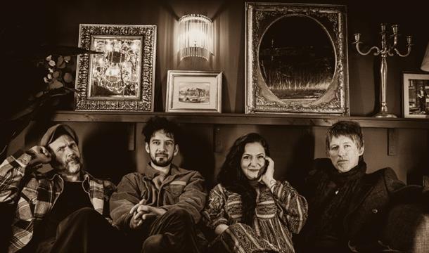 sepia image of Stevie Watts and the Whirlybirds sitting on a sofa