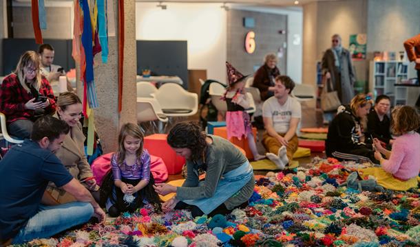The Mossy Carpet Torre Abbey Aged 4 upwards picture of children sitting on a giant pompom blanket