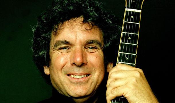 John Etheridge image holding a guitar