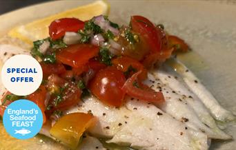 A prepared dish of fresh fish with tomato at Portofino restaurant, Wellswood, Torquay. Part of England's Seafood FEAST.