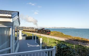 View of the steam train passing Waterside Holiday Park, Paignton, Devon