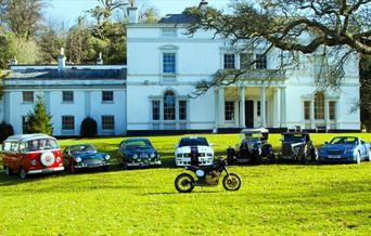 Classic vehicles parked in front of Lupton House, Brixham, Devon