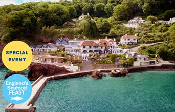 A view looking across the water to Cary Arms & Spa, with the pier in the foreground. Part of England's Seafood FEAST.